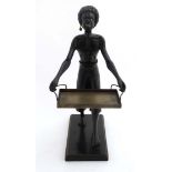 Tobacco shop figure : An early 20thC model of a negro figure on base holding a tray selling cigars
