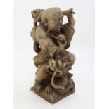 A late 19thC carved soapstone figure of a figure and dragon. Signed under .