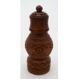 A late 19thC / early 20thC carved coquilla nut formed as a a caster / pounce pot.