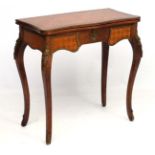 A Continental parquetry topped and ormolu mounted serpentine shaped fold over card table 29 1/2"