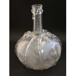 An onion shaped decanter with long neck and trailed decoration with etched foliate and bird detail.