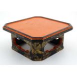 A Japanese lacquer squared pot stand with canted corners.