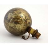 A 19thC glass witches ball , amber gold in colour.