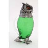 A late 20thC silver plate and green glass novelty claret jug in the form of an owl with glass eyes.