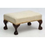 An early 20thC stained wood ball and claw upholstered footstool 10" high x 18 3/4" long x 14" wide