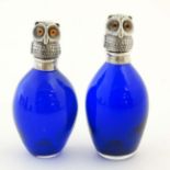 2 late 20thC Blue glass scent bottles both with white metal tops formed as owls.