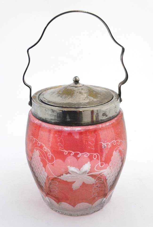 An early 20thC glass biscuit barrel with silver plated mounts lid and handle,