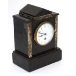 Mantel clock : a slate cased mantel clock ( time piece ) with marble edging ,
