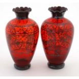 A pair of 20thC ruby glass vases with flared rims and applied silvered decoration depicting