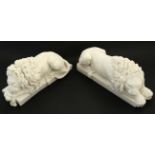 A pair of Parian ware style lions recumbent upon a plinth, both bearing medallions under.