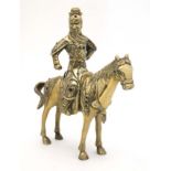 A cast brass oriental figure on horseback inlaid with semi-precious stones 9" high