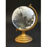 A desk top glass globe on gilt metal stand,