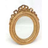 A Continental gilt gesso and wood oval wall mirror.