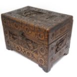 An Oriental carved camphor wood small hinged lidded box 12 1/2" wide x 8 1/2" high x 8" deep