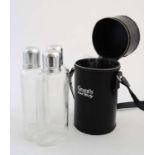 Leather triple flask : a zip opening cylindrical black leather case with shoulder strap opening to