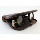 An pair of opera / theatre glasses constructed within a pig skin case and titled 'la mignonne,