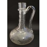 A 19thC wine decanter / jug with loop handle and having etched foliate and bird decoration to the