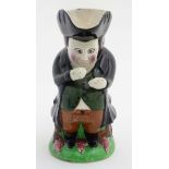 A 19thC Snuff-Taker ' Toby ' Jug, formed as a gentleman in black coat and hat sat taking snuff,