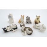 A collection of seven Royal Worcester cat figurines,