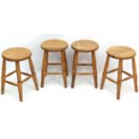 A collection of 4 Victorian style stained beech circular stools with ring turned legs.