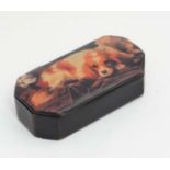 A 19thC black lacquer papier-mache snuff box with canted corners and later applied applied image