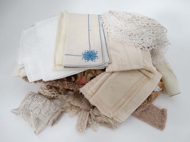 A quantity of assorted table linen lace etc.
