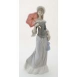 A Lladro figure '' Walking '' modelled as a lady with a parasol, number 5003, 1978-1994,