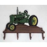 A 21stC painted cast metal plaque of tractor with four coat hooks CONDITION: Please