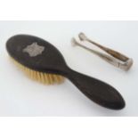 A hardwood brush with silver cartouche hallmarked London 1911 together with a pair of white metal