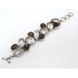 A silver bracelet set with various stones CONDITION: Please Note - we do not make