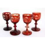 A matched set of 4 ruby glass short pedestal glasses with fruiting vine decoration approx 3 3/4"