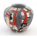 A Modernist style ceramic bulbous vase, having textured abstract decoration in red,