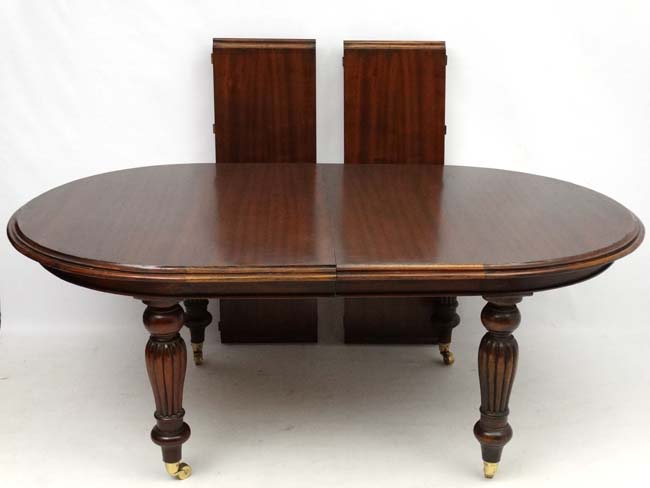 A late 20thC Victorian style mahogany D-ended wind out dining table, 80" long,