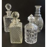 Four assorted glass decanters, three with stoppers.