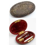 An early 19thC etui of oval shape with gilded brass top opening to reveal a red velvet lined