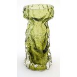 A olive green glass vase of textured naturalistic bark like form. Probably by Ingrid glass .