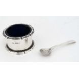 An early 20thC silver salt with blue glass liner.