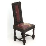 A Victorian Caroleon style carved oak single chair with an oak leaf and mythical fish carving .
