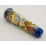 A Moorcroft salad server handle , tube lined with floral decoration in shades of blue, pink,