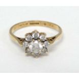 A 9ct gold ring set with white stones in a daisy setting CONDITION: Please Note -