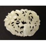 A carved and pierced white jade? roundel with wildfowl decoration approx 2 1/8" high