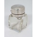 A glass salts bottle with silver mounts and hinged lid.