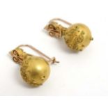 A pair of gilt metal drop earrings with Etruscan style decoration .