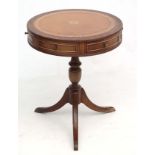 Mid Century / Hollywood Regency : A 1980's mahogany small drum table with gold tooled leather