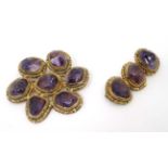 2 gilt white metal brooches set with amethysts,