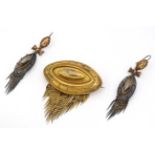 A 19thC gilt metal brooch of elliptical from with graduated tassel drop decoration ,