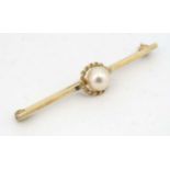 A 9ct gold bar brooch set with central pearl with rope twist border 2” wide CONDITION: