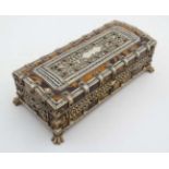 A 19thC Tortoiseshell and ivory table casket standing on four hairy lions paw feet and opening to