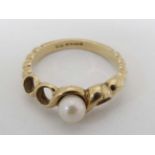 A 9ct gold dress ring set with central pearl.