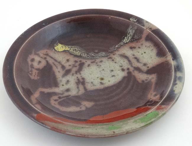 A large Studio pottery charger decorated to centre with the image of a rearing horse with - Image 4 of 4
